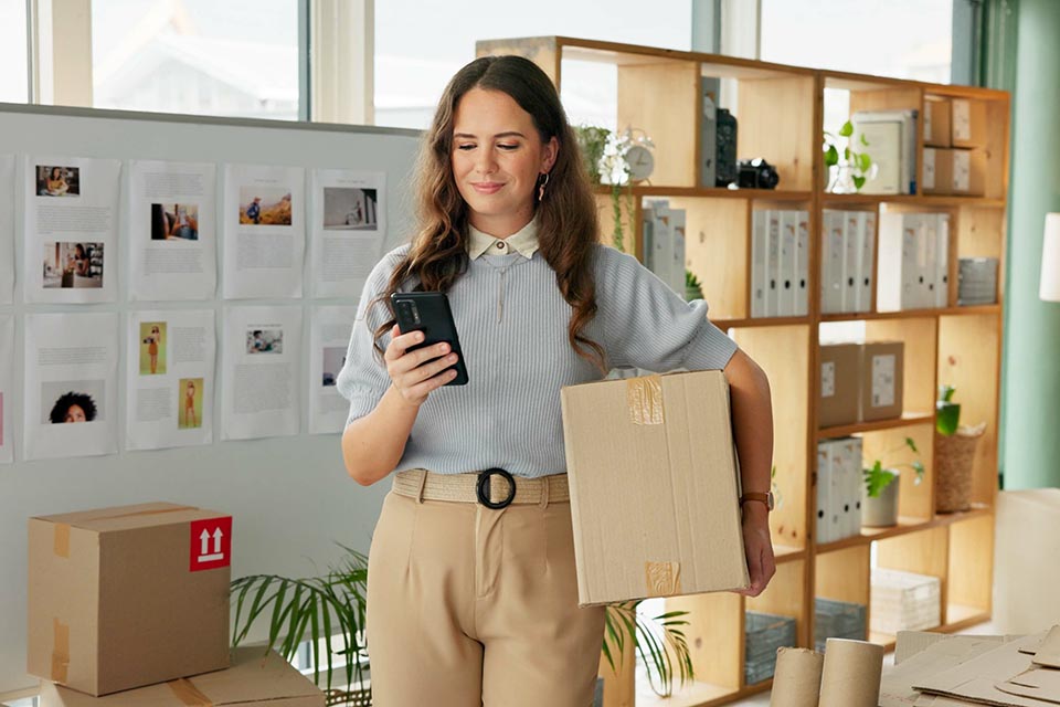Phone, woman and package for delivery of small business of e commerce order, online information and planning transport. Owner, mobile and logistics for supply chain, supplier invoice and courier app