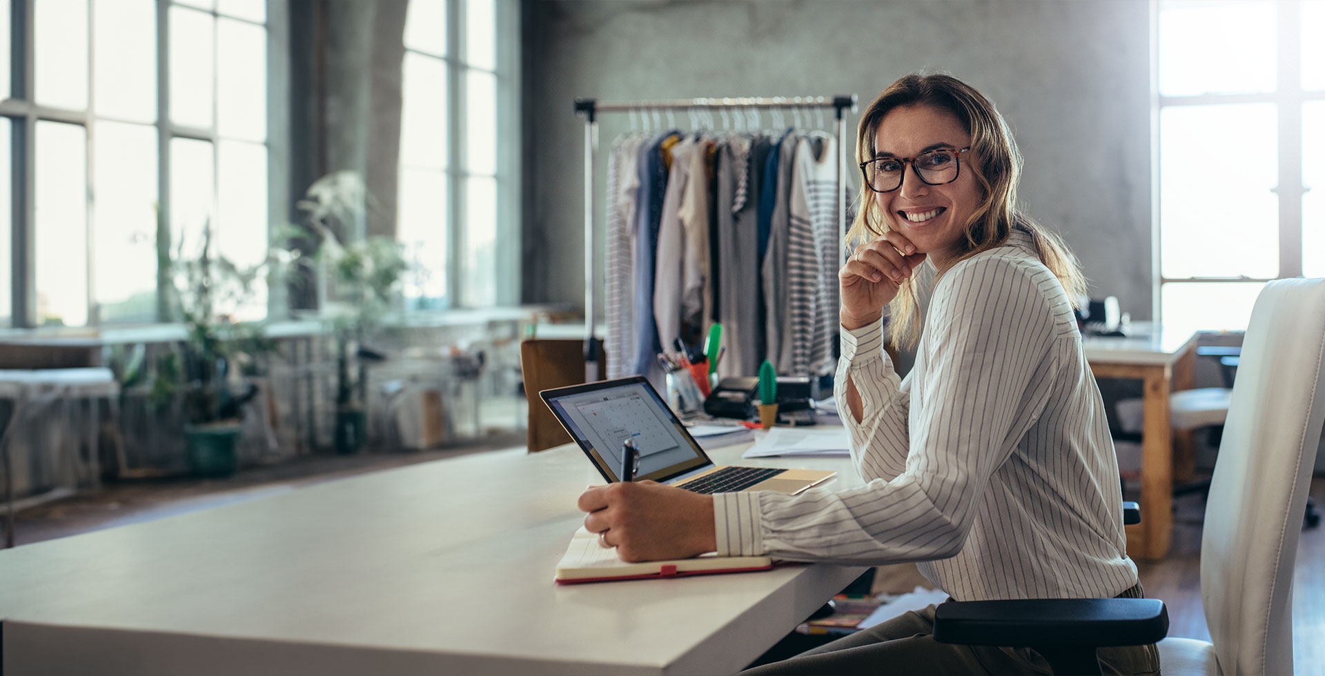 Smiling young woman taking note of orders from customers.